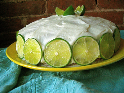 An AUSTRALIA: BANANA, LIME AND COCONUT CAKE with limes around the edge and on top