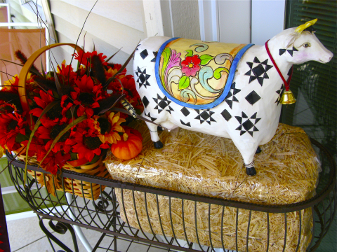 Jim Shore cow with a fall basket of flowers