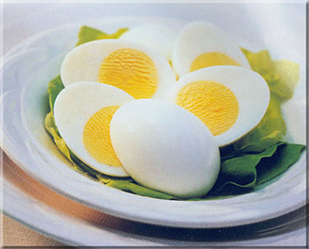 hard boiled eggs peeled & cut in half in a bowl