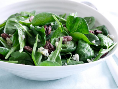 A bowl of SPINACH SALAD WITH PECANS & GORGONZOLA