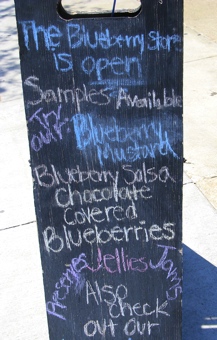 Chalkboard with Blueberry mustard, blueberry salsa, chocolate covered blueberries - samples available