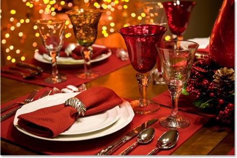 A festive table set with red napkins and glasses