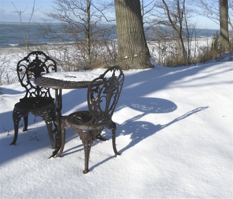 Patio chairs in the snow overlooking Lake Michigan- copyright Sharon Pisacreta
