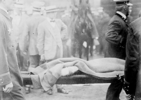 Photo of a body being carried away from the capsized Eastland - 1915