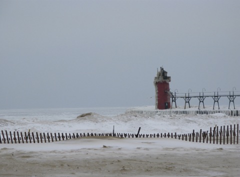 A frozen beach and lighthouse at South Haven, Michigan