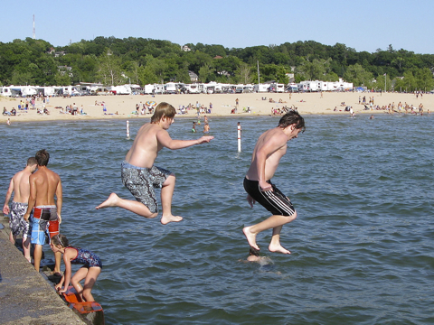 Kids jumping from the pier at Grand Haven, Michigan