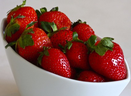 Whole strawberries in a white bowl