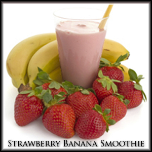 Glass of strawberry banana smoothie surrounded by strawberries and bananas
