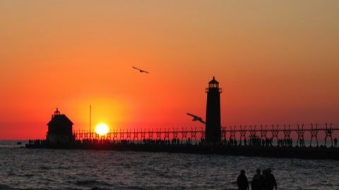 Sunset over the lighthouses on the pier at Grand Haven, Michigan