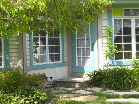 white cottage with turquoise trim