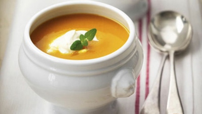 Spicy pumpkin soup in a white bowl