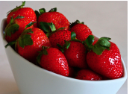 Ripe strawberries in a white bowl