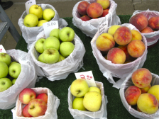 different varieties of apples in white bags for sale